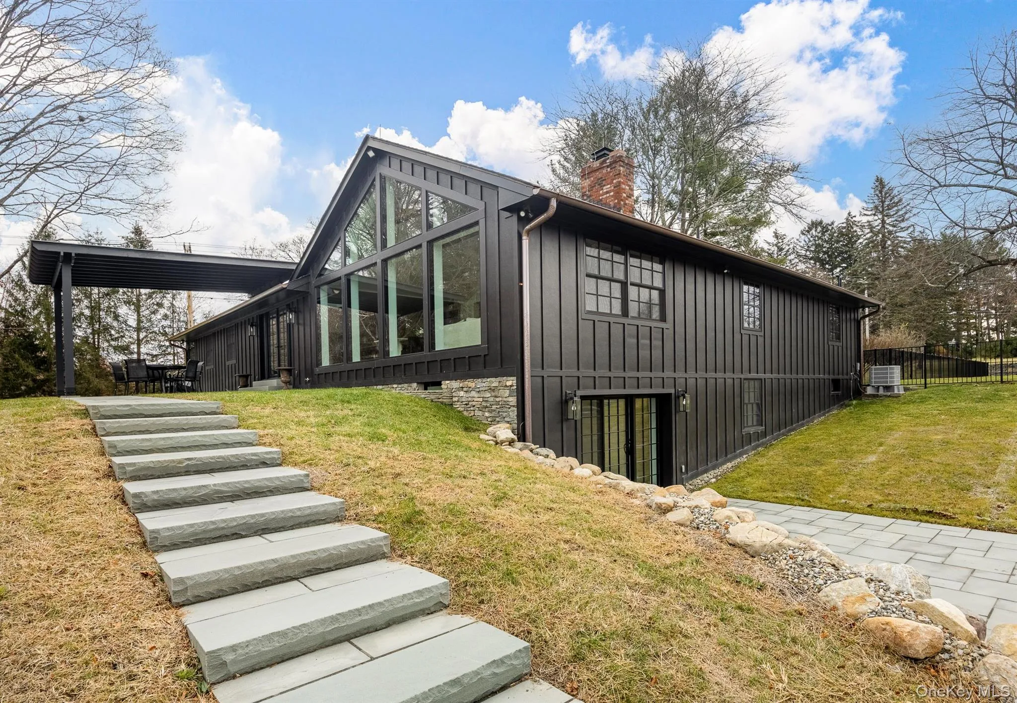 View of property exterior, board and batten siding. View of property exterior, board and batten siding.