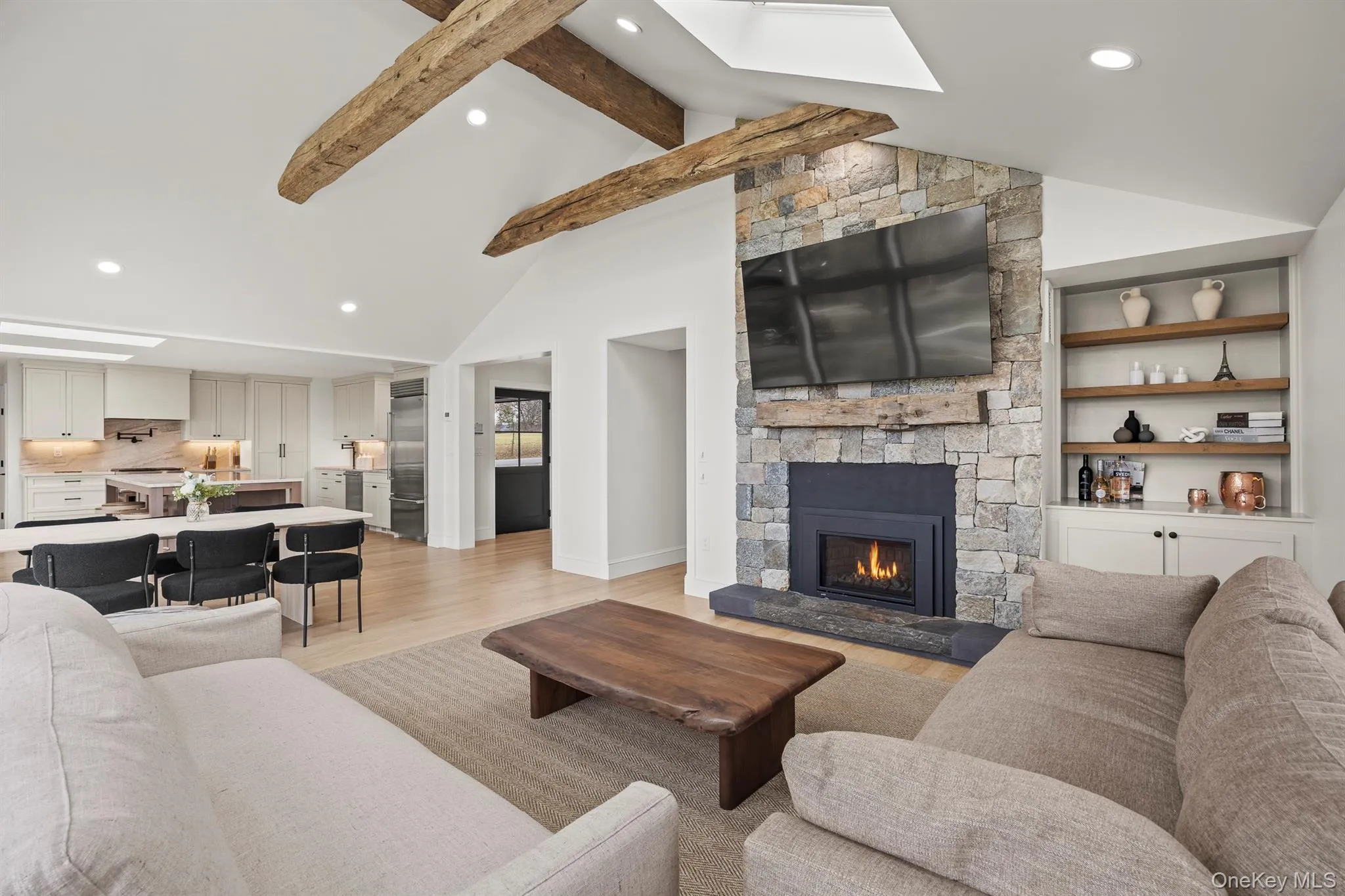 Living area featuring a gas fireplace and beamed ceiling Living area featuring a gas fireplace and beamed ceiling