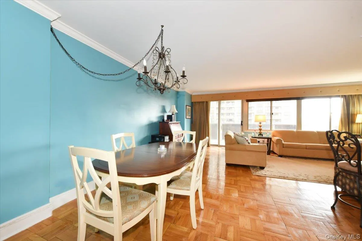 Dining area featuring a chandelier and crown molding Dining area featuring a chandelier and crown molding