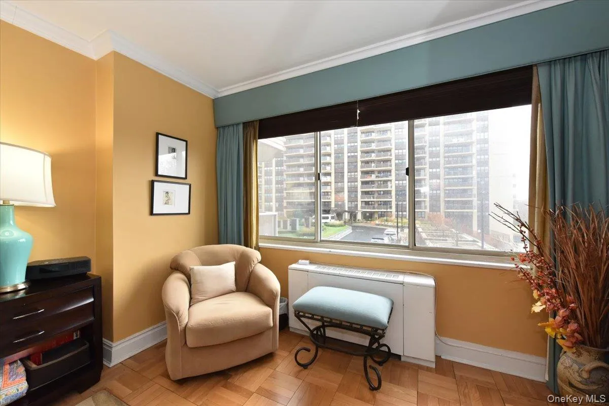Living area featuring radiator and crown molding Living area featuring radiator and crown molding