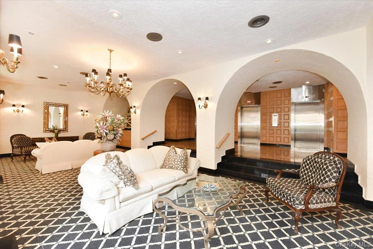Lobby with a textured ceiling, stairway, and recessed lighting Lobby with a textured ceiling, stairway, and recessed lighting