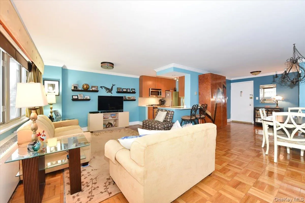 Living area with crown molding and a chandelier Living area with crown molding and a chandelier