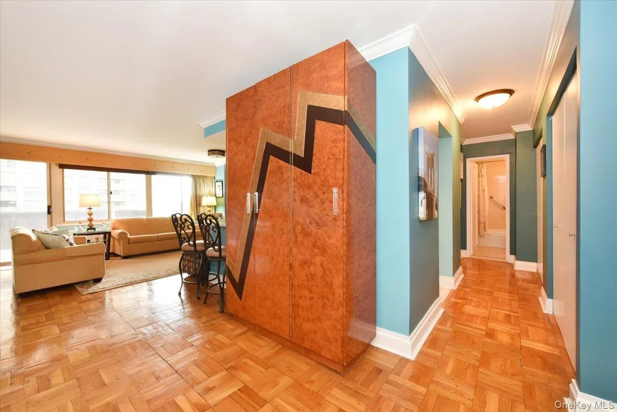Hall with crown molding and baseboards Hall with crown molding and baseboards