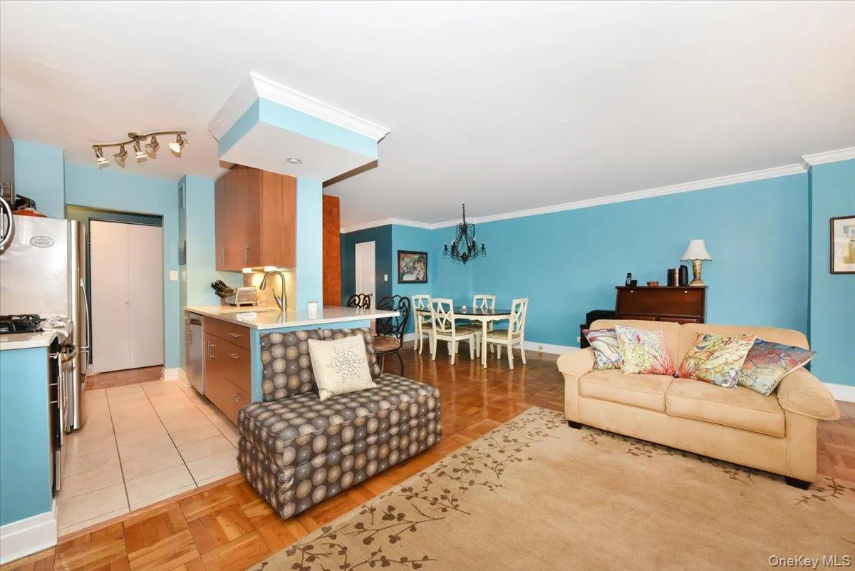 Living area with a chandelier and ornamental molding Living area with a chandelier and ornamental molding