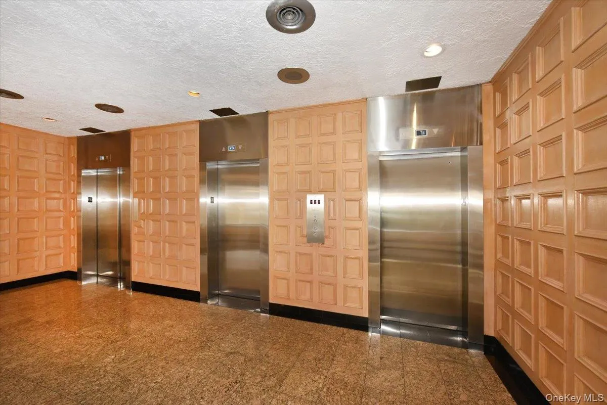Building lobby featuring a textured ceiling and recessed lighting Building lobby featuring a textured ceiling and recessed lighting