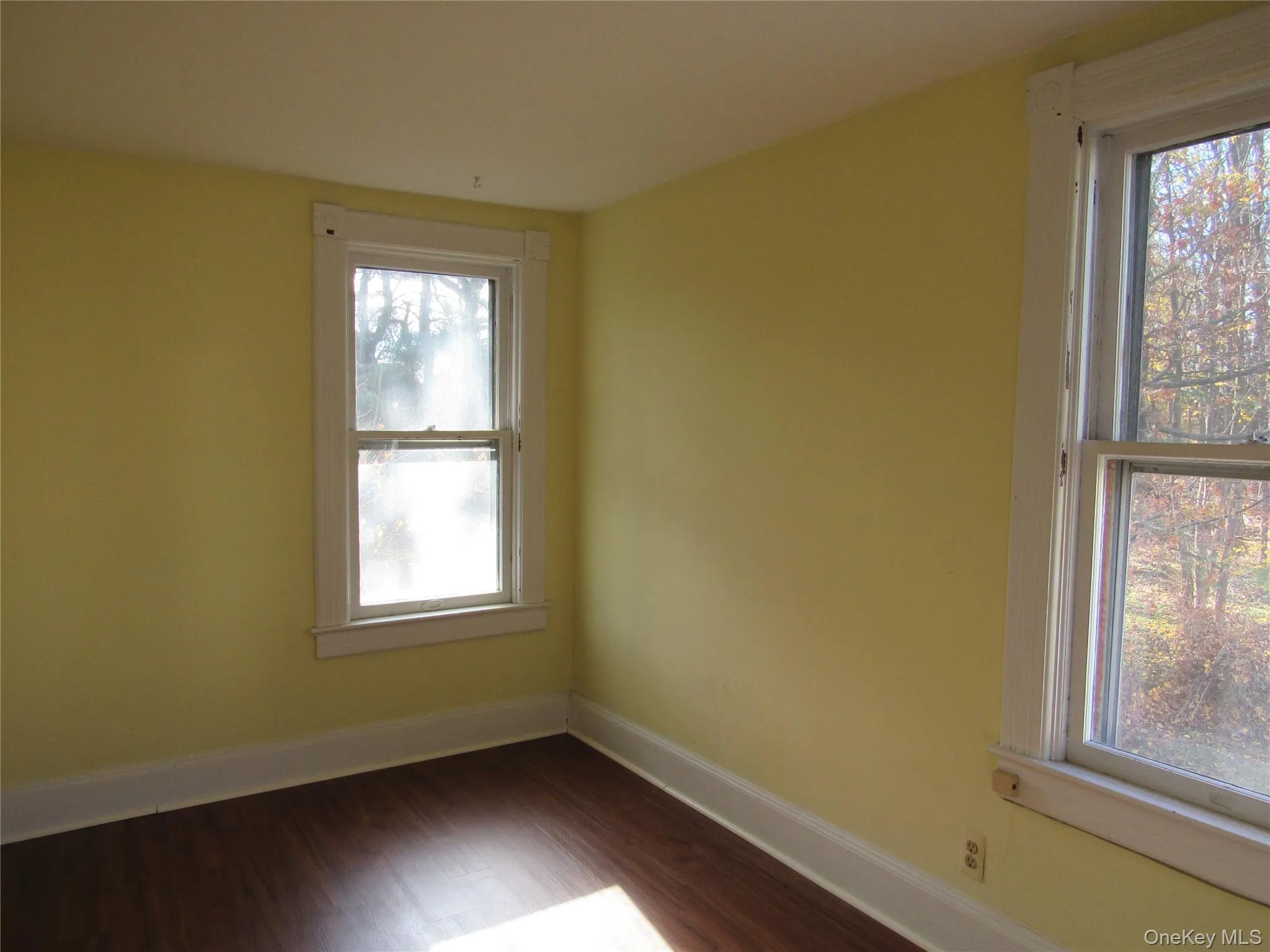 Bedroom #4 with healthy amount of natural light and dark wood finished floors Bedroom #4 with healthy amount of natural light and dark wood finished floors
