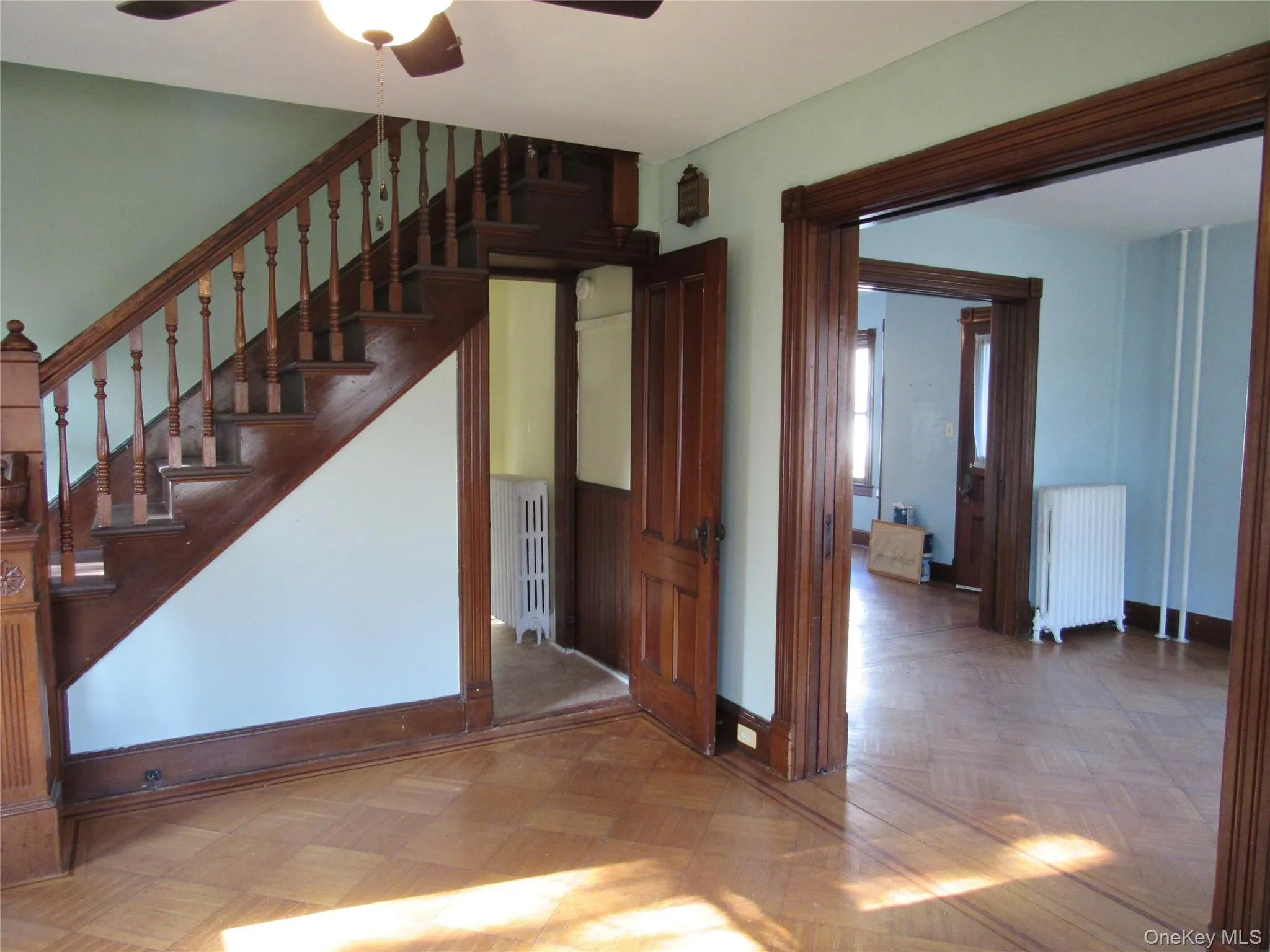 Stairs featuring radiator and ceiling fan Stairs featuring radiator and ceiling fan