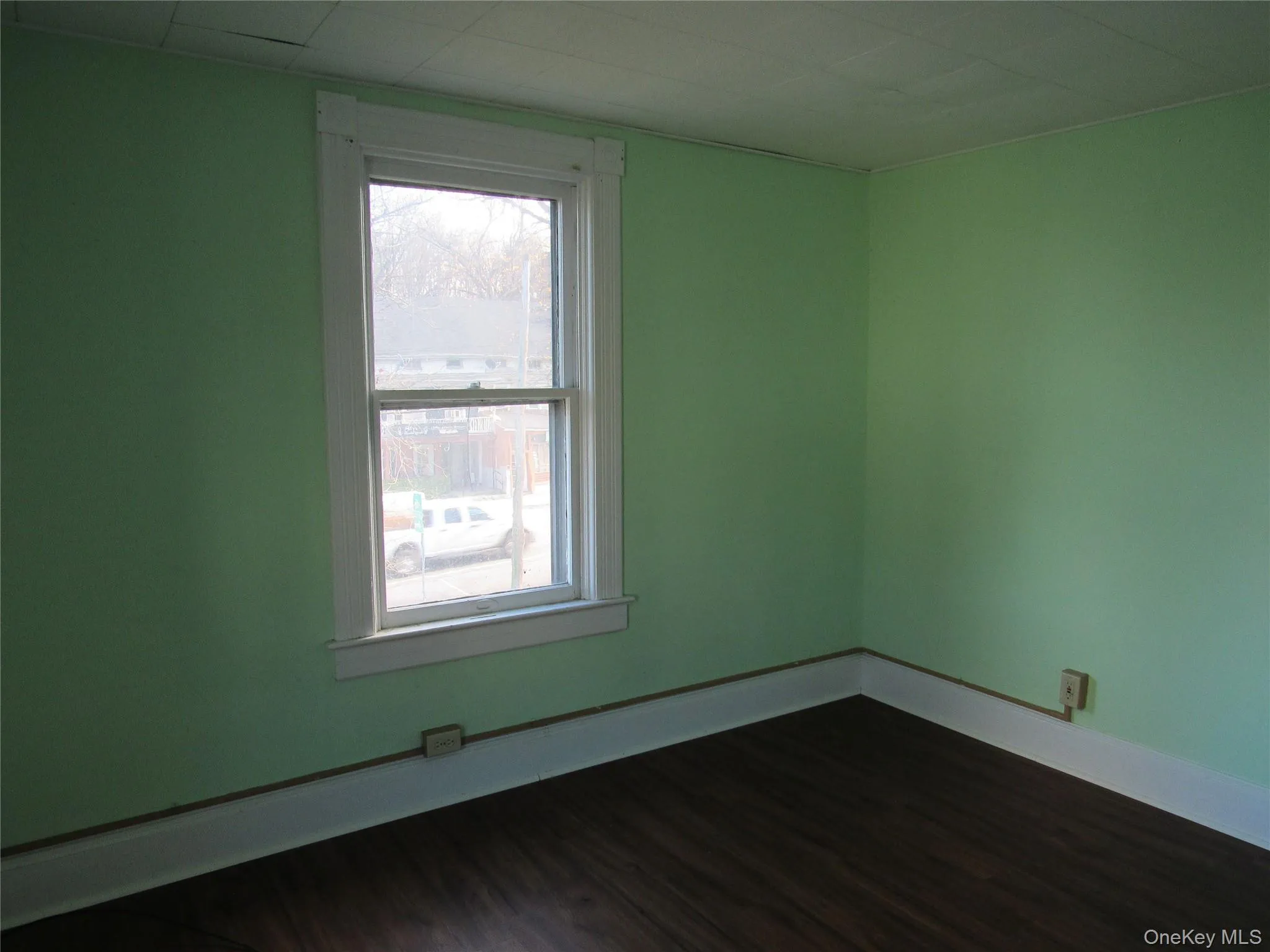 Bedroom #2 featuring dark wood-style floors and baseboards Bedroom #2 featuring dark wood-style floors and baseboards