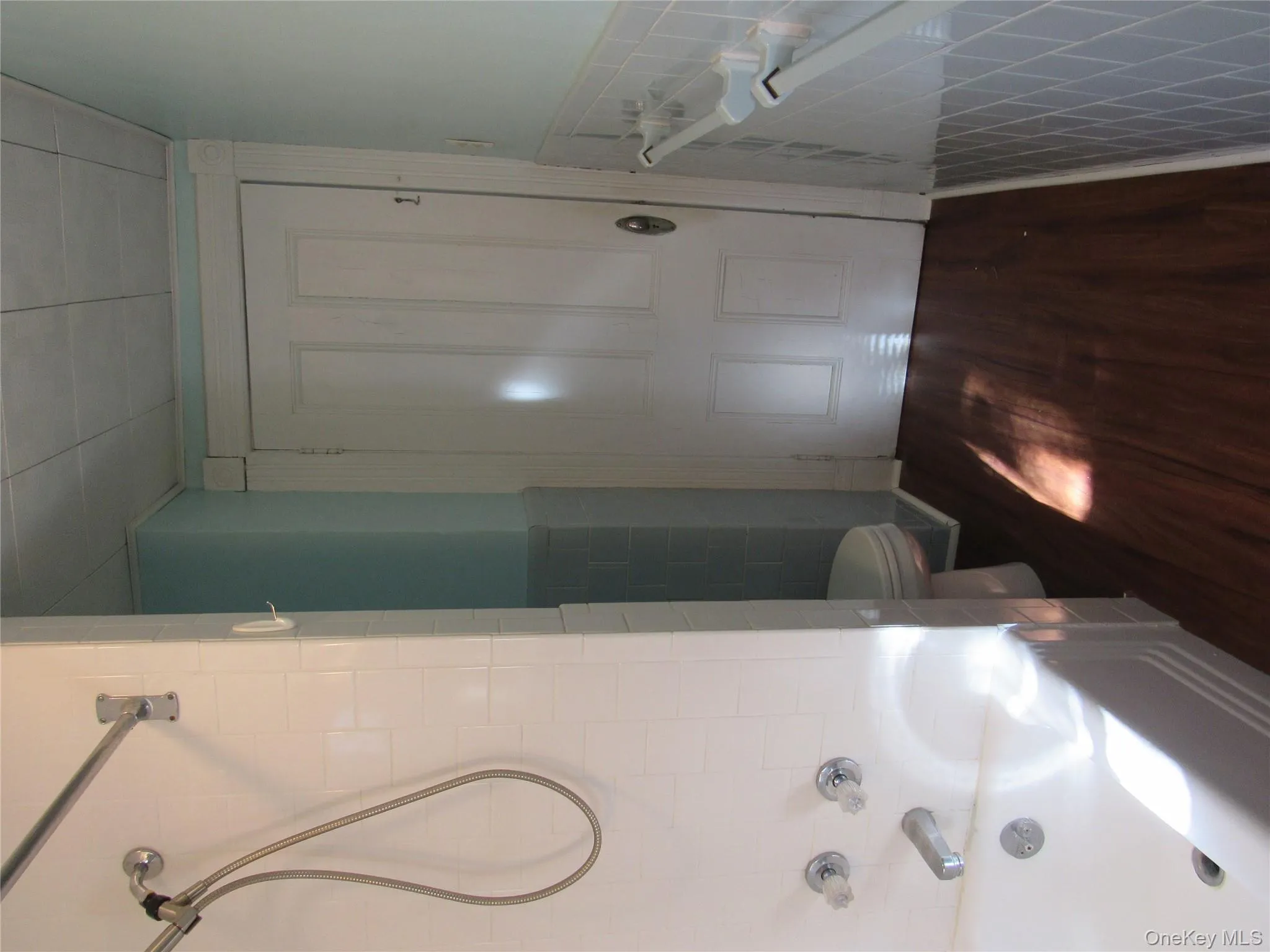 Full bath with dark wood-style floors and tub / shower combination Full bath with dark wood-style floors and tub / shower combination