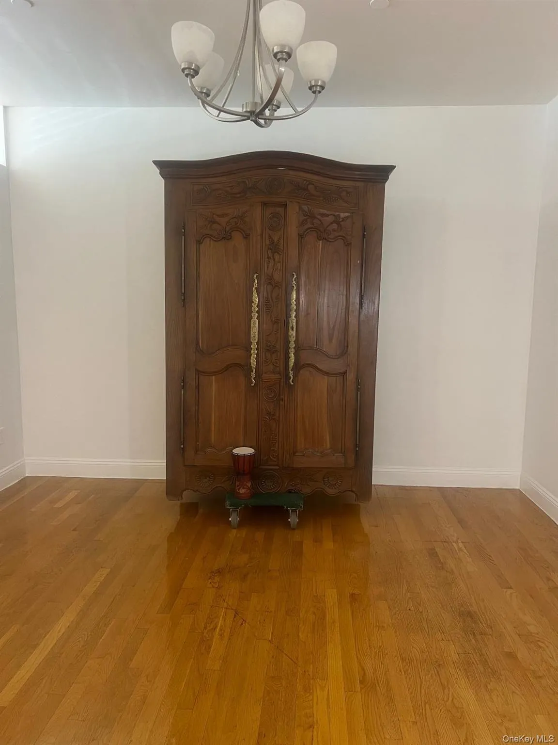 Detailed view of a chandelier and wood finished floors Detailed view of a chandelier and wood finished floors