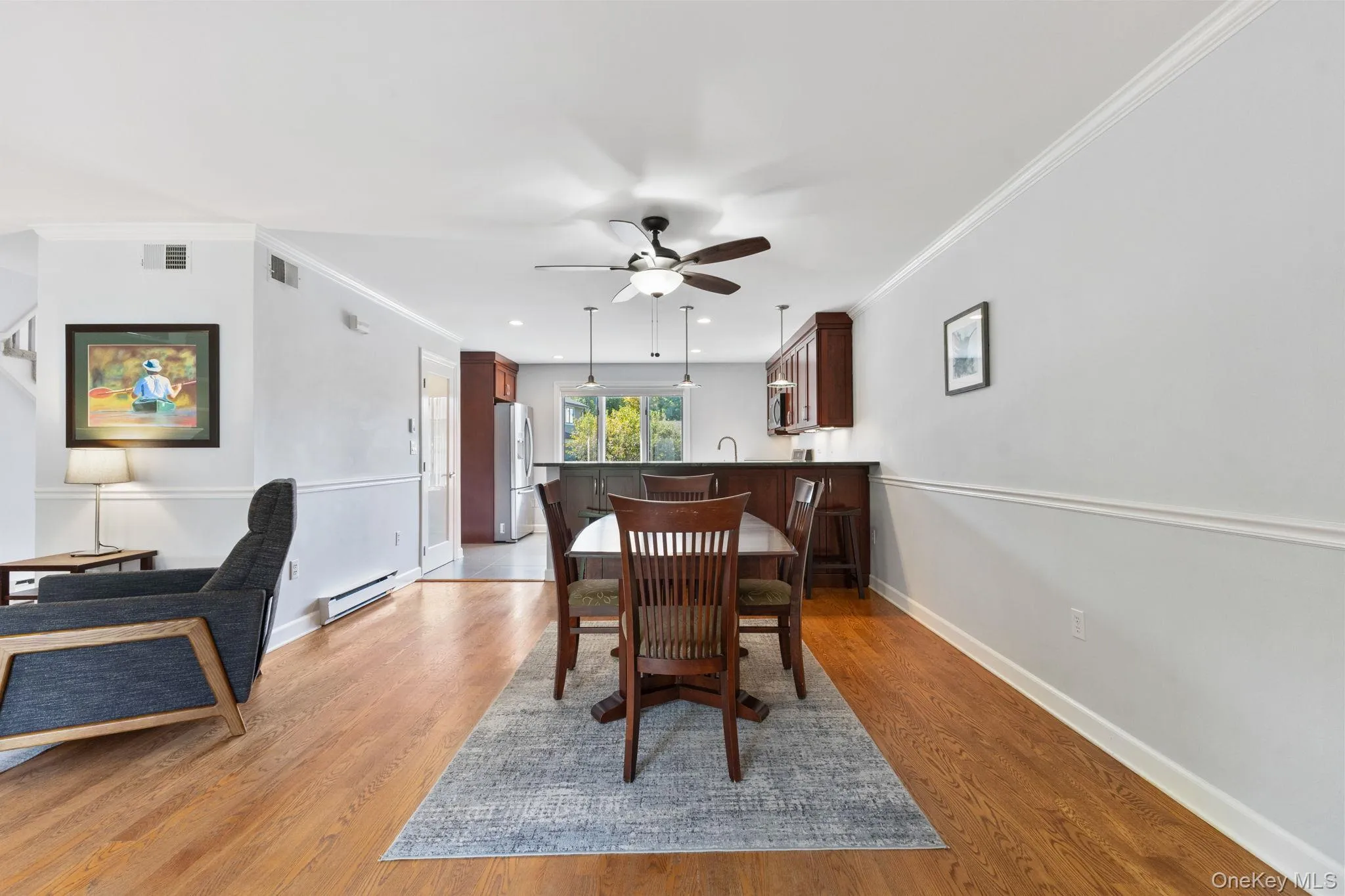 Dining area with wood floors and an open flow to both the kitchen and living room. Dining area with wood floors and an open flow to both the kitchen and living room.