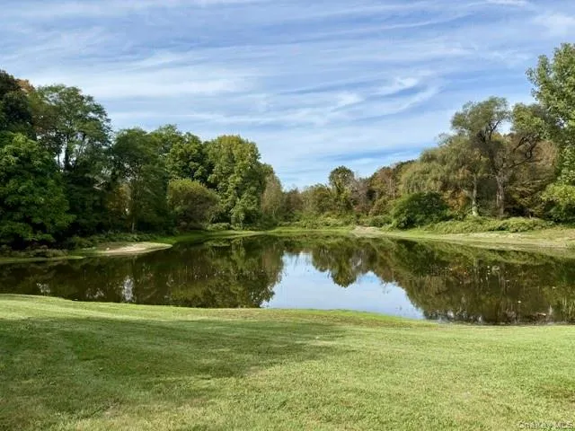 Tranquil pond with scenic views for peaceful enjoyment. Tranquil pond with scenic views for peaceful enjoyment.