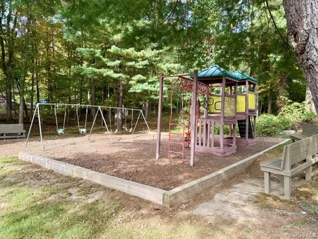 Playground with swings, a playset, and benches for kids and families. Playground with swings, a playset, and benches for kids and families.