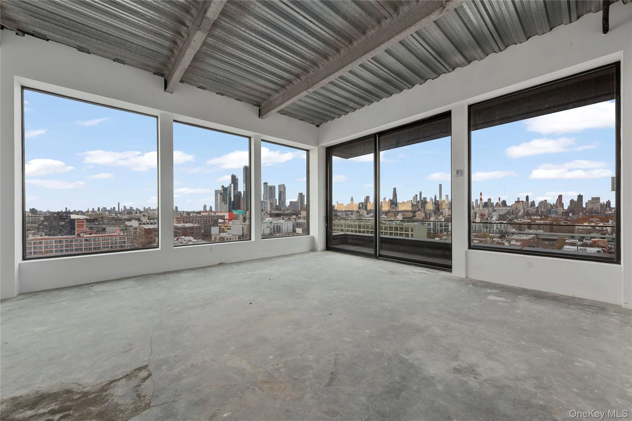 Spare room with concrete floors and a view of skyline Spare room with concrete floors and a view of skyline