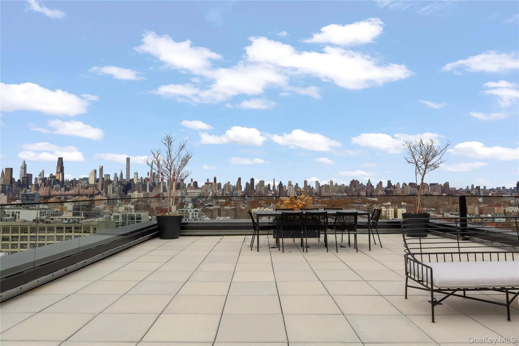 View of patio with a skyline view and outdoor dining space View of patio with a skyline view and outdoor dining space