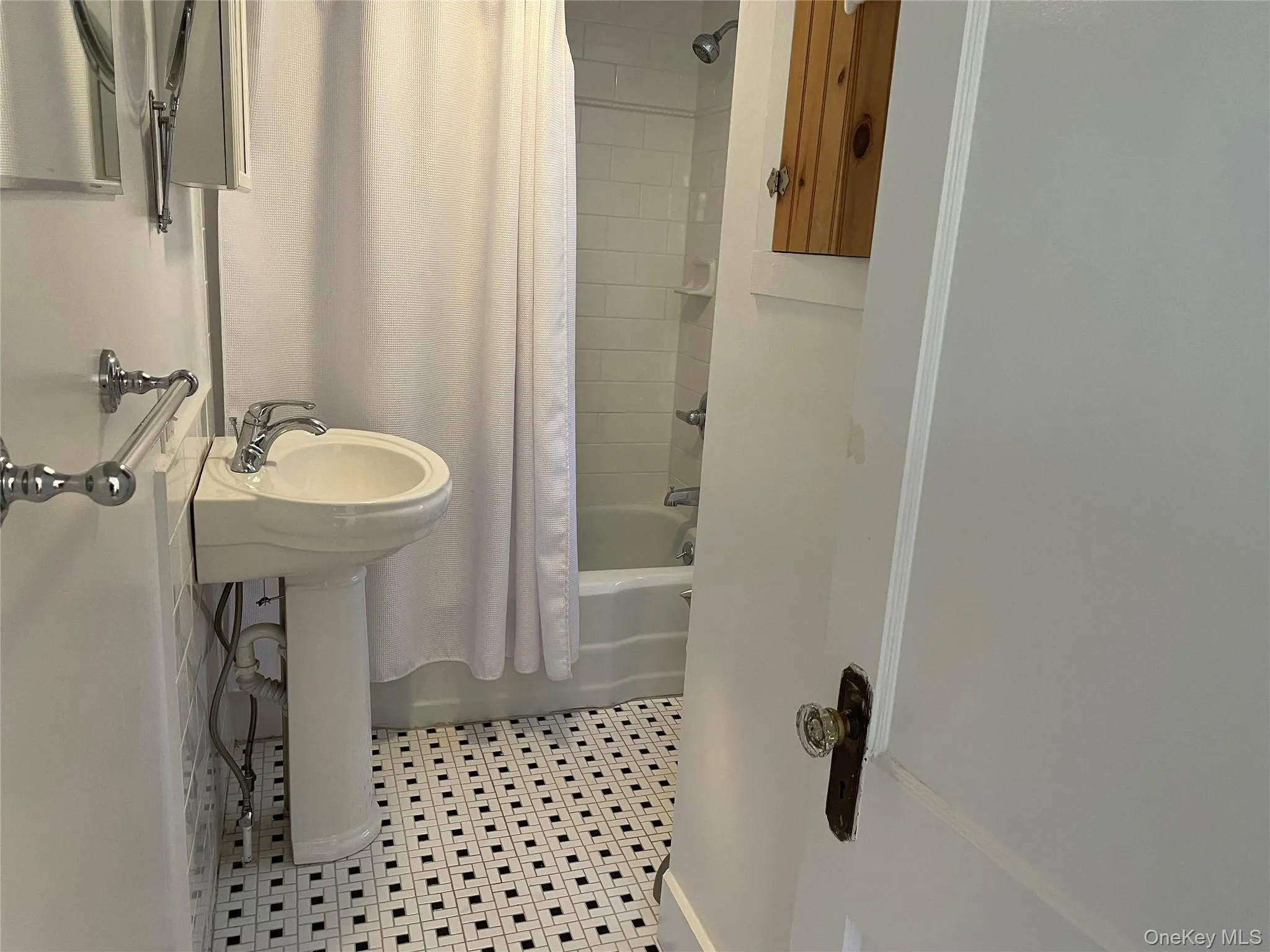 Bathroom featuring shower / bathtub combination with curtain and light tile patterned flooring Bathroom featuring shower / bathtub combination with curtain and light tile patterned flooring