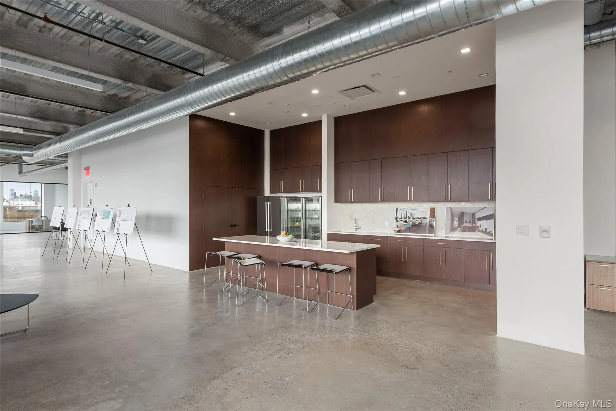 Kitchen with a kitchen breakfast bar, a large island, a high ceiling, modern cabinets, and open floor plan Kitchen with a kitchen breakfast bar, a large island, a high ceiling, modern cabinets, and open floor plan