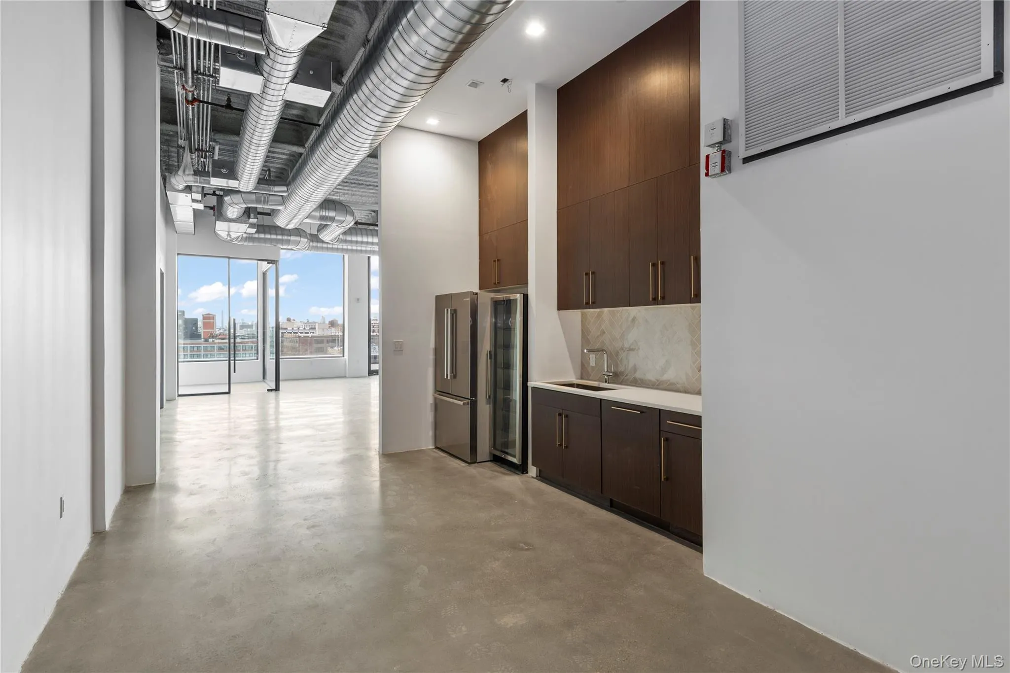 Hallway featuring concrete flooring and beverage cooler Hallway featuring concrete flooring and beverage cooler