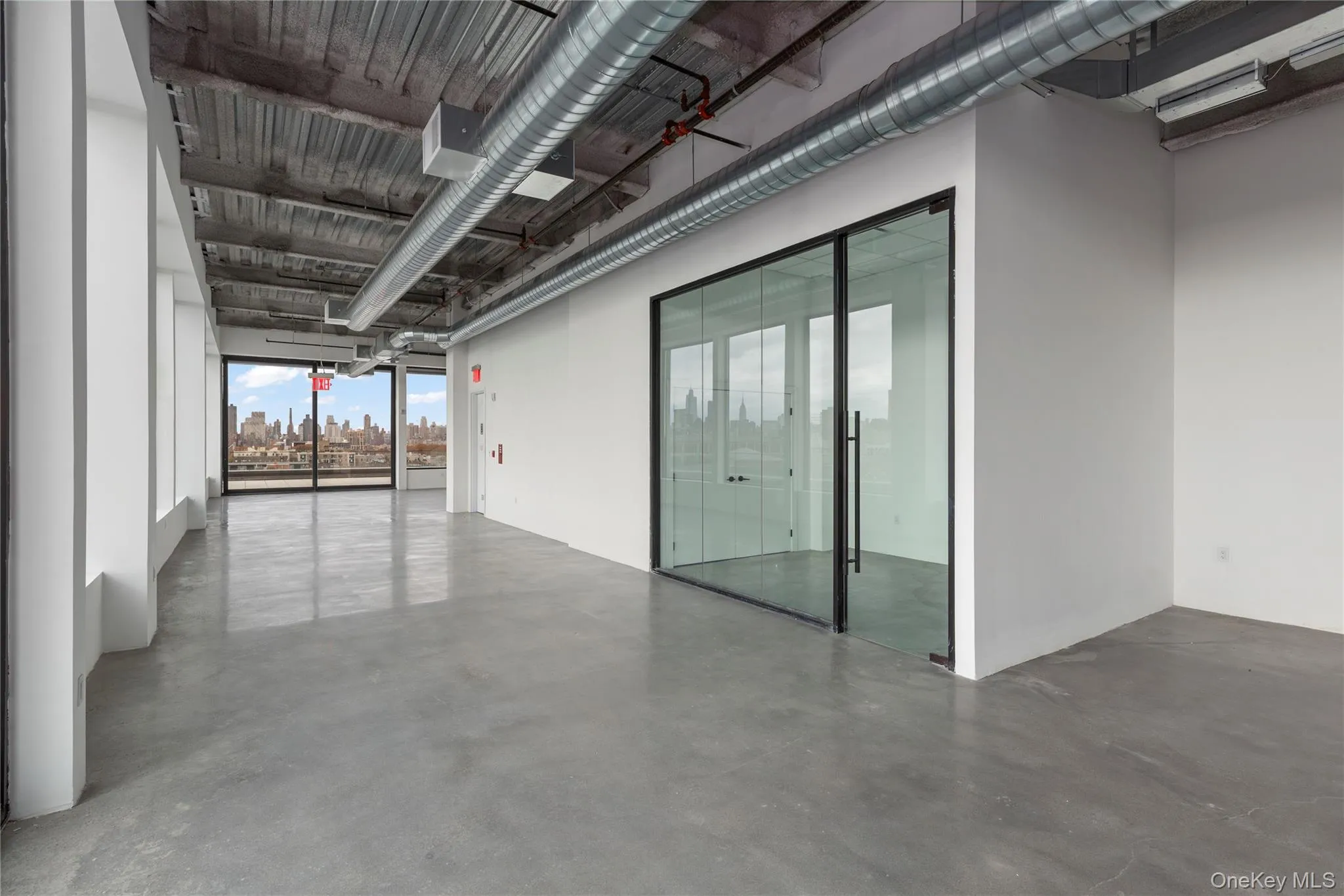 Spare room featuring concrete flooring Spare room featuring concrete flooring