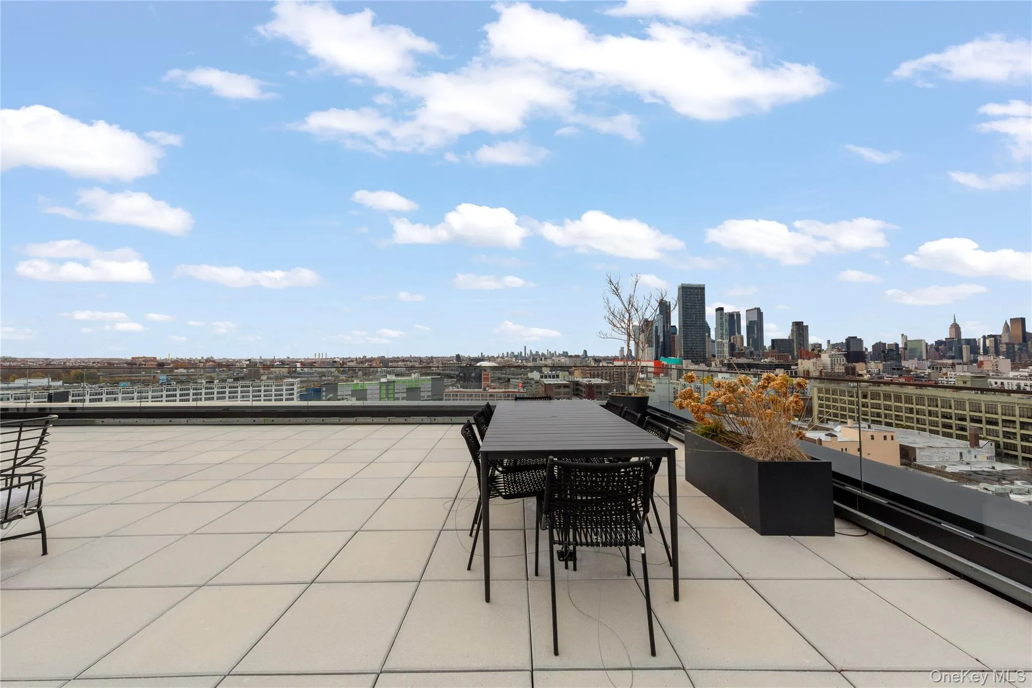 View of patio with a skyline view and outdoor dining space View of patio with a skyline view and outdoor dining space