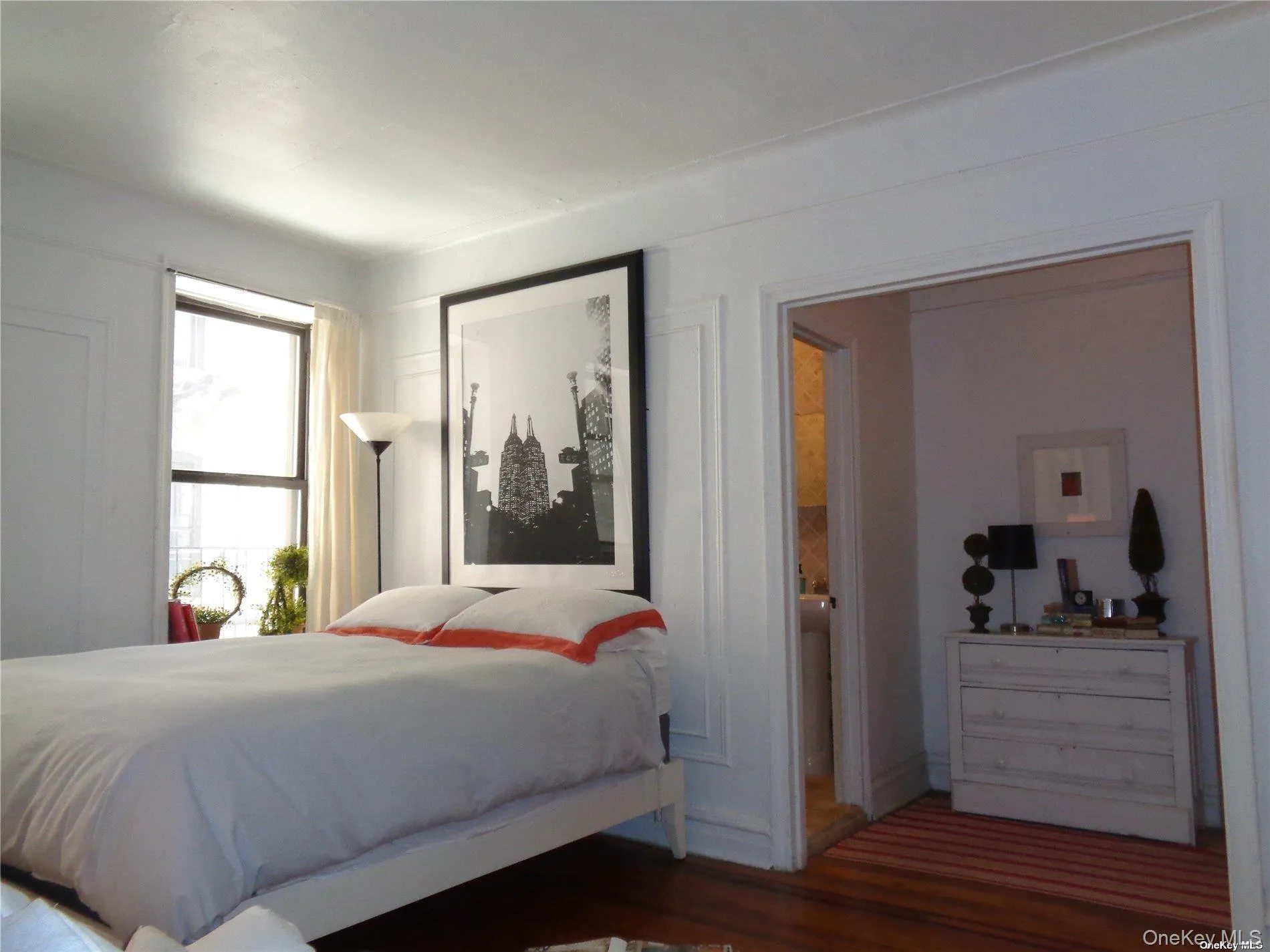 Bedroom with wood finished floors and baseboards Bedroom with wood finished floors and baseboards