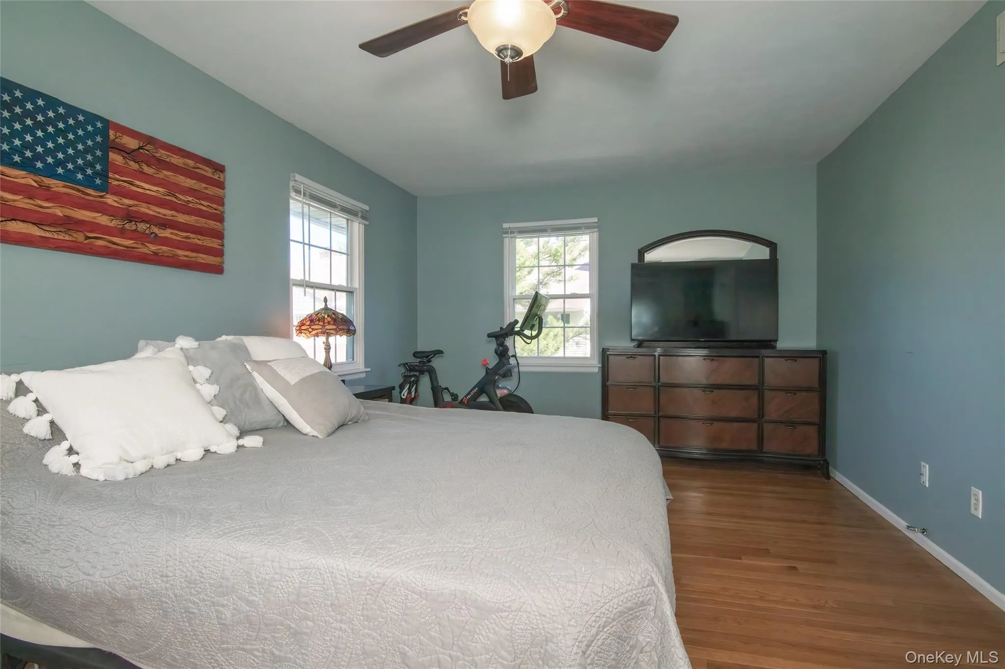Bedroom with wood finished floors and a ceiling fan Bedroom with wood finished floors and a ceiling fan