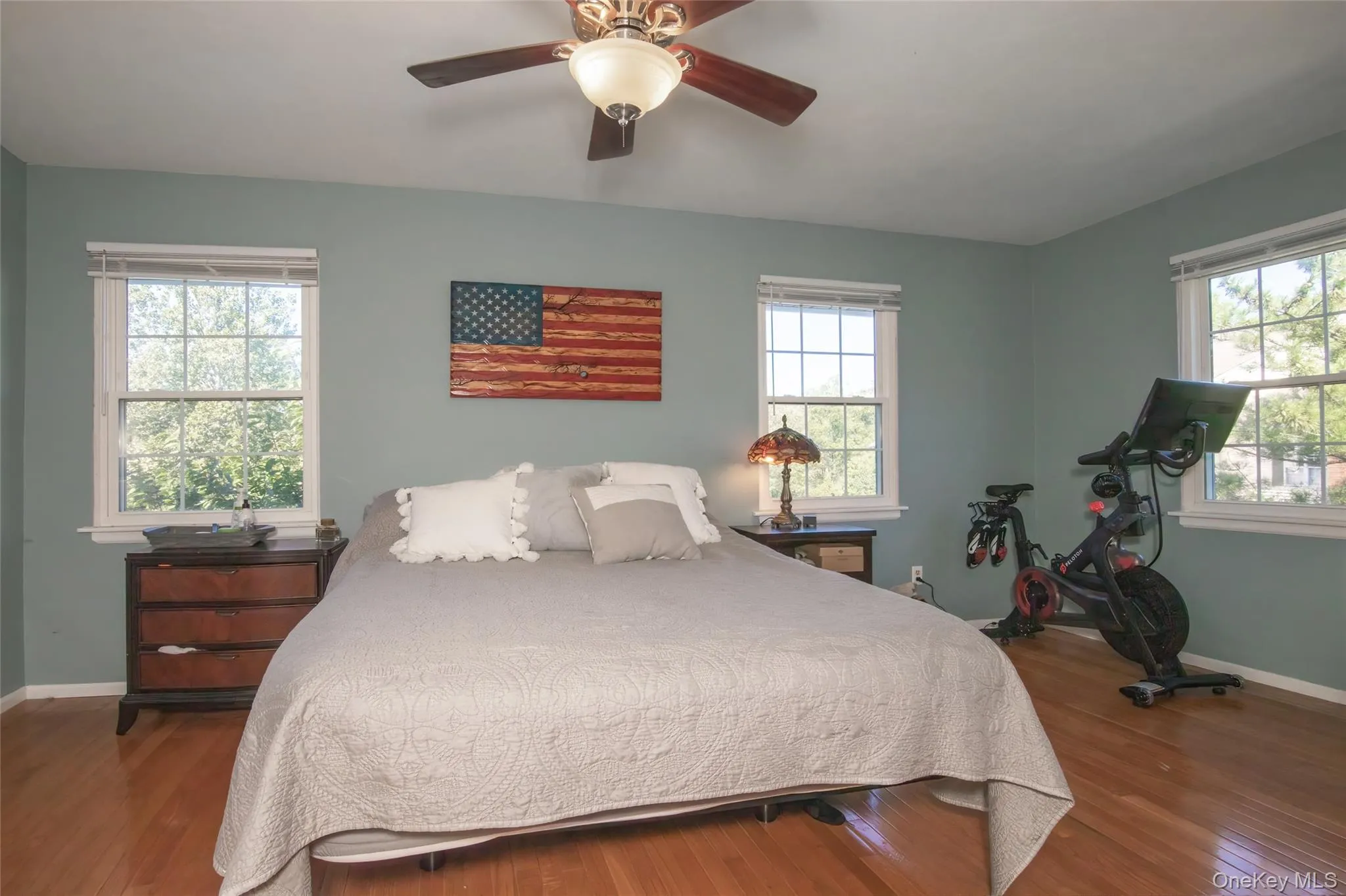 Bedroom with dark wood-style floors and a ceiling fan Bedroom with dark wood-style floors and a ceiling fan