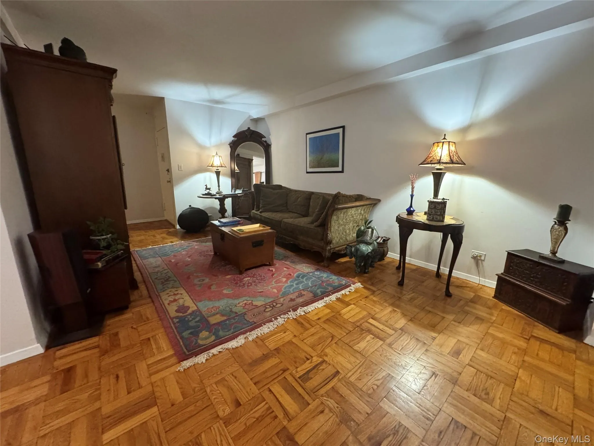 Living room featuring baseboards and arched walkways Living room featuring baseboards and arched walkways