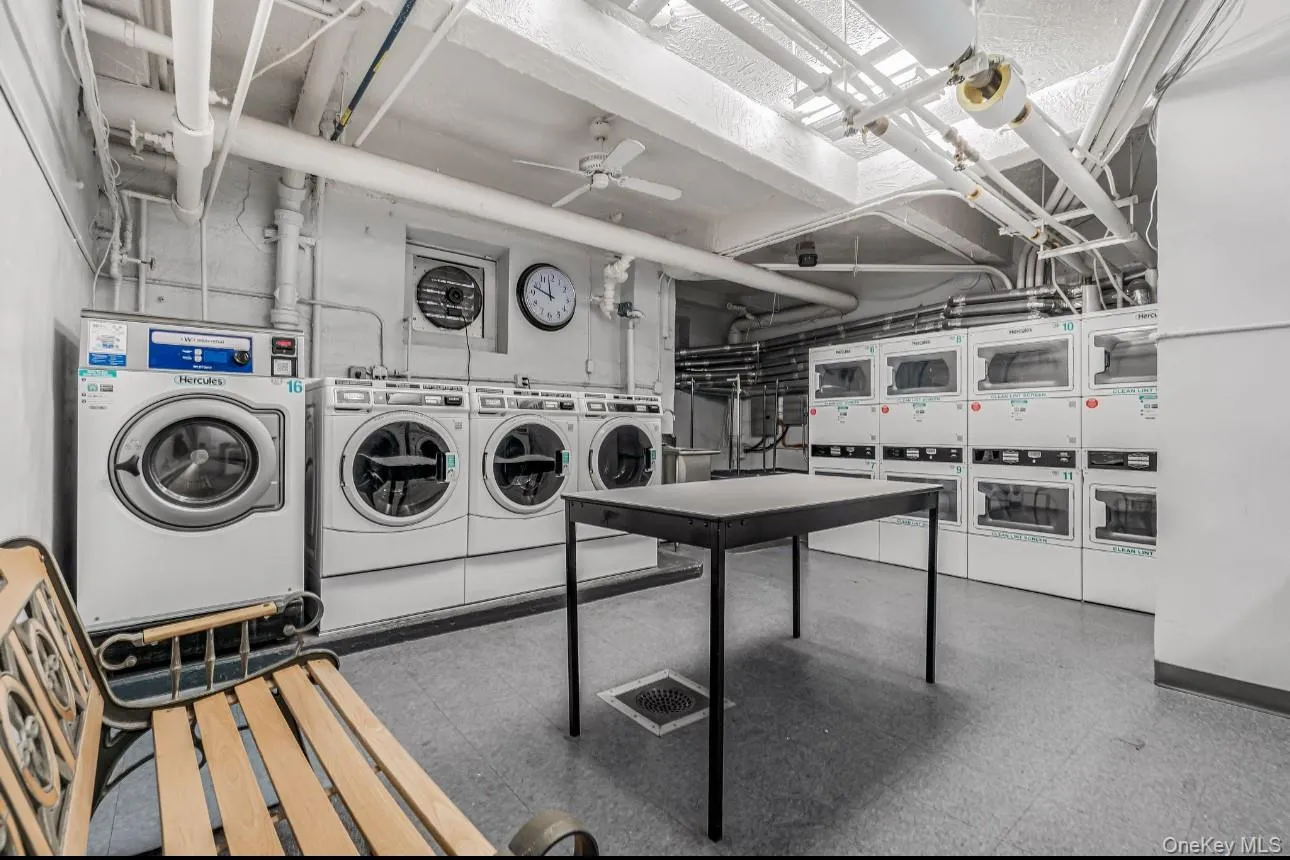 Shared laundry room with washer and dryer and a ceiling fan Shared laundry room with washer and dryer and a ceiling fan