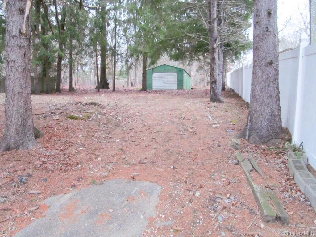 View of yard featuring an outdoor structure and a garage View of yard featuring an outdoor structure and a garage