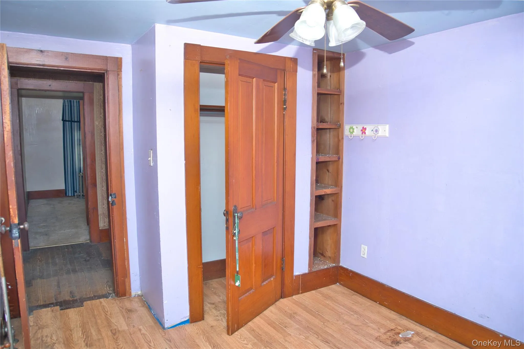 Unfurnished bedroom featuring light wood finished floors, a closet, and a ceiling fan Unfurnished bedroom featuring light wood finished floors, a closet, and a ceiling fan
