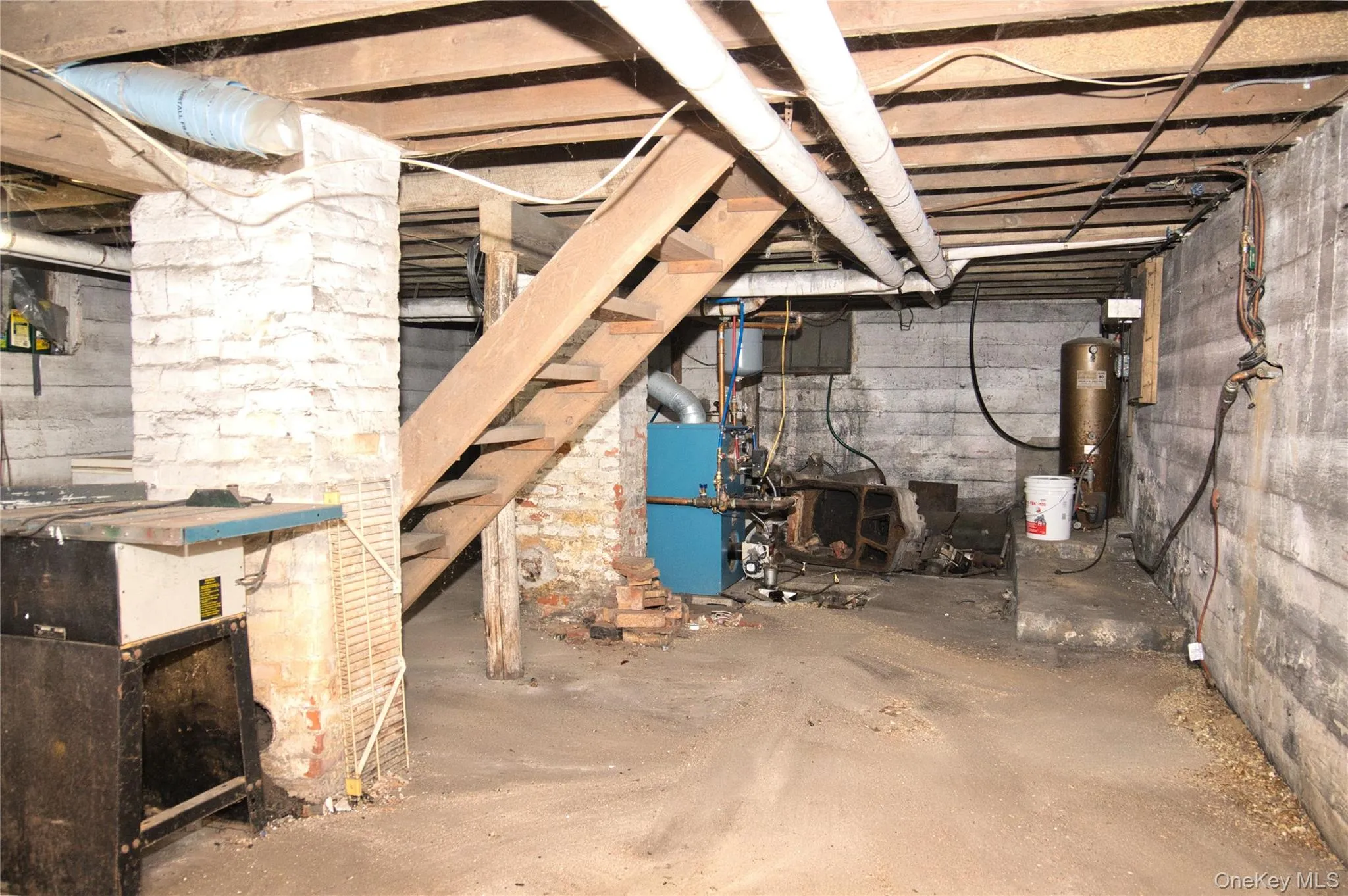 Unfinished basement with a heating unit and gas water heater Unfinished basement with a heating unit and gas water heater