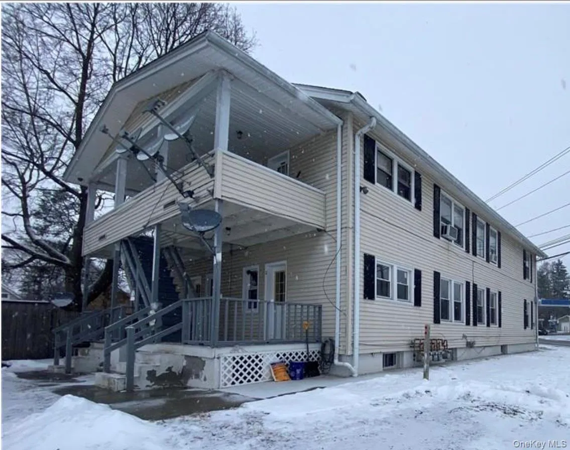 View of front of house featuring a porch and a balcony View of front of house featuring a porch and a balcony