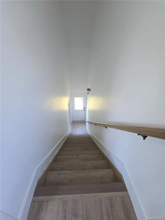 Staircase with wood finished floors and baseboards Staircase with wood finished floors and baseboards