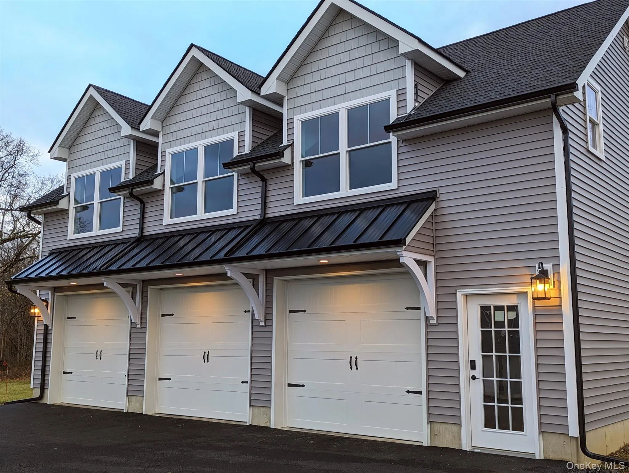 View of front of home with an attached garage, driveway, and roof with shingles View of front of home with an attached garage, driveway, and roof with shingles