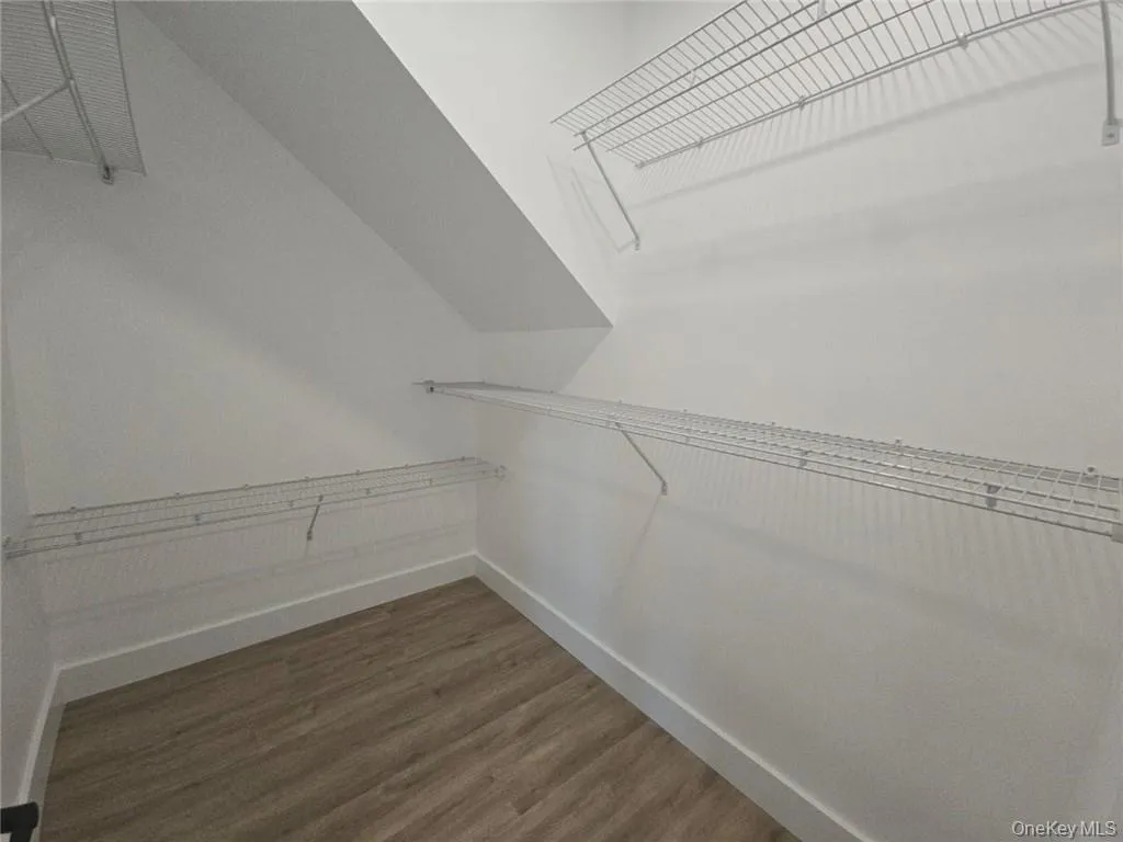Spacious closet with wood finished floors Spacious closet with wood finished floors