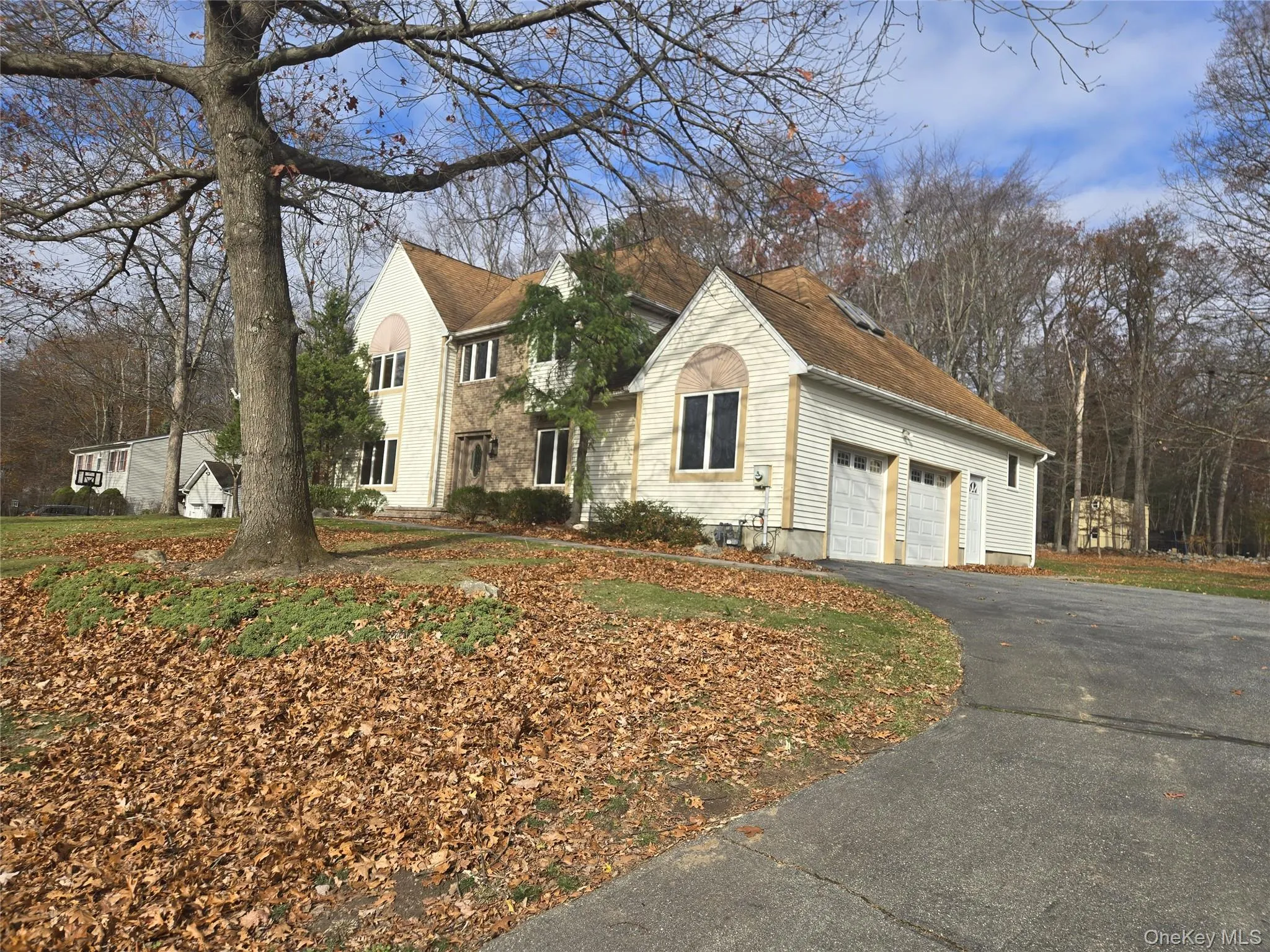 View of front of house with a garage and asphalt driveway View of front of house with a garage and asphalt driveway