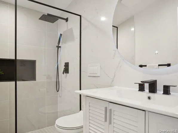 Full bathroom featuring vanity and a shower stall Full bathroom featuring vanity and a shower stall