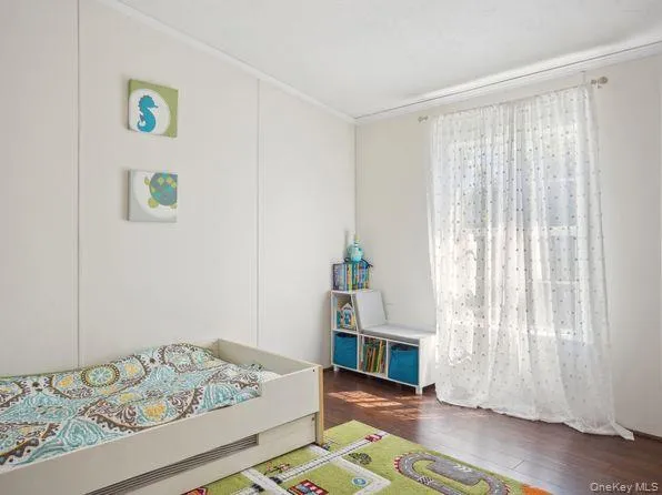 Bedroom featuring dark wood-type flooring Bedroom featuring dark wood-type flooring