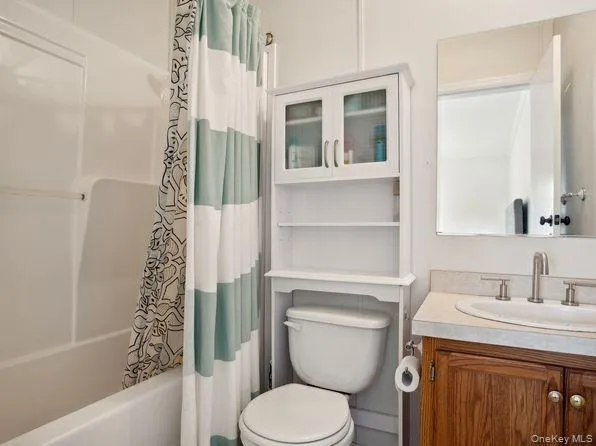 Bathroom with shower / bathtub combination with curtain and vanity Bathroom with shower / bathtub combination with curtain and vanity