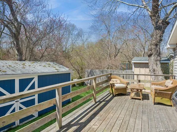 Wooden deck with a storage shed and an outdoor hangout area Wooden deck with a storage shed and an outdoor hangout area