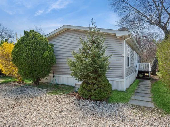 View of side of home with a wooden deck