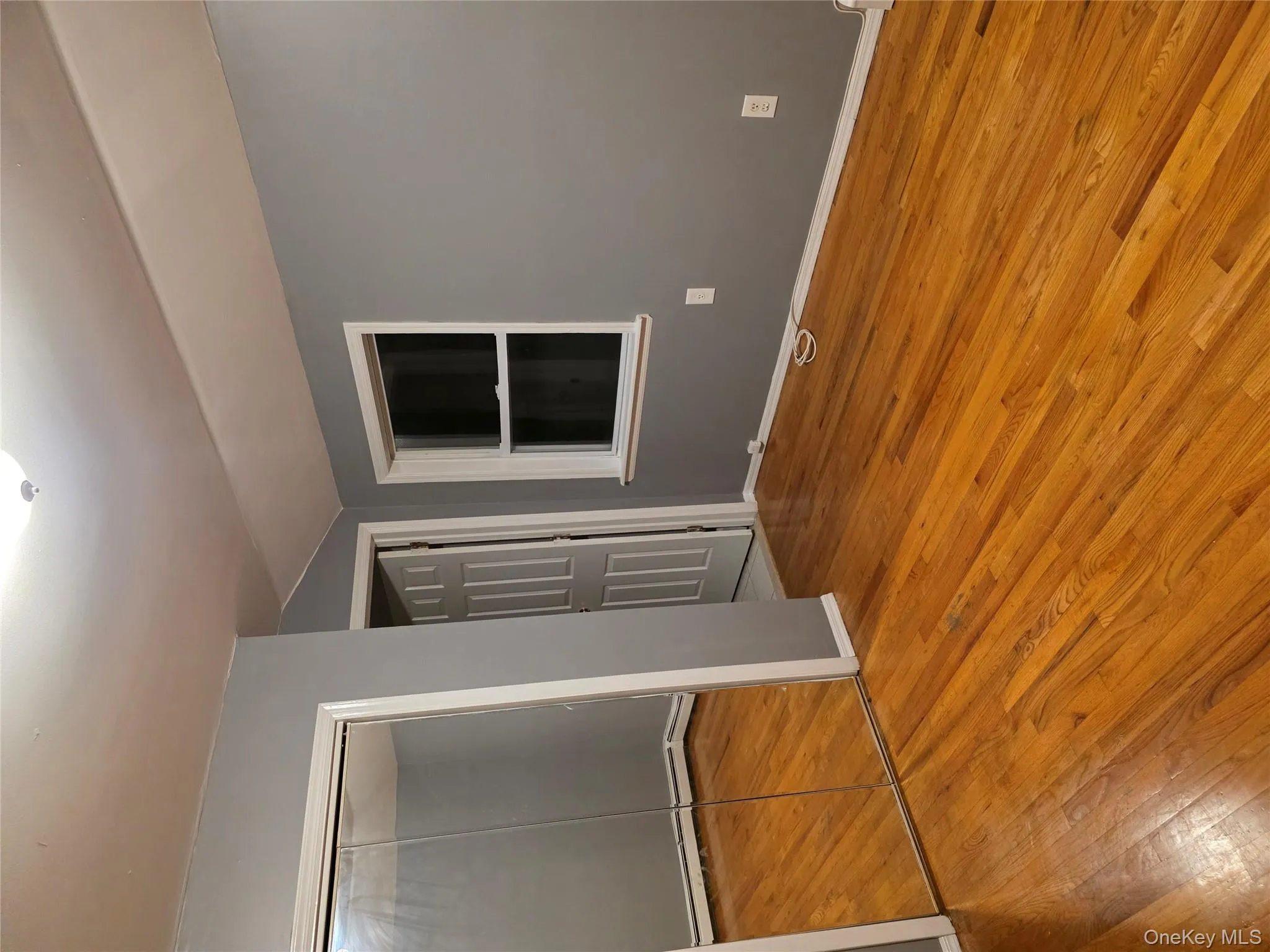 Unfurnished bedroom featuring vaulted ceiling, a closet, light wood-style floors, and a baseboard heating unit Unfurnished bedroom featuring vaulted ceiling, a closet, light wood-style floors, and a baseboard heating unit