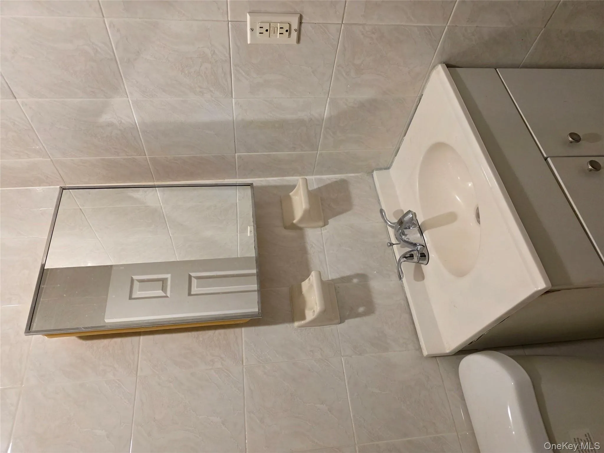 Half bath featuring tile walls and vanity Half bath featuring tile walls and vanity