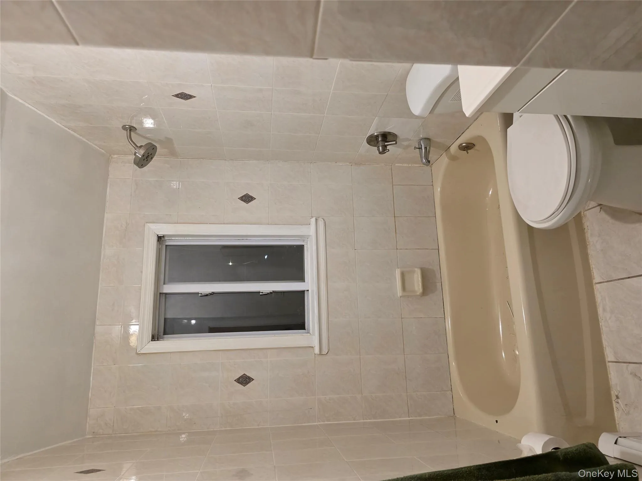 Bathroom featuring bathtub / shower combination, tile patterned floors, vanity, and baseboard heating Bathroom featuring bathtub / shower combination, tile patterned floors, vanity, and baseboard heating