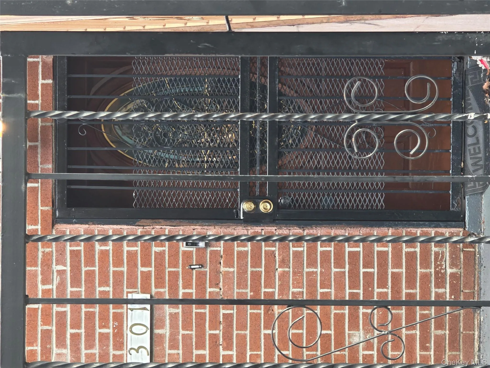 Property entrance with brick siding and a gate Property entrance with brick siding and a gate