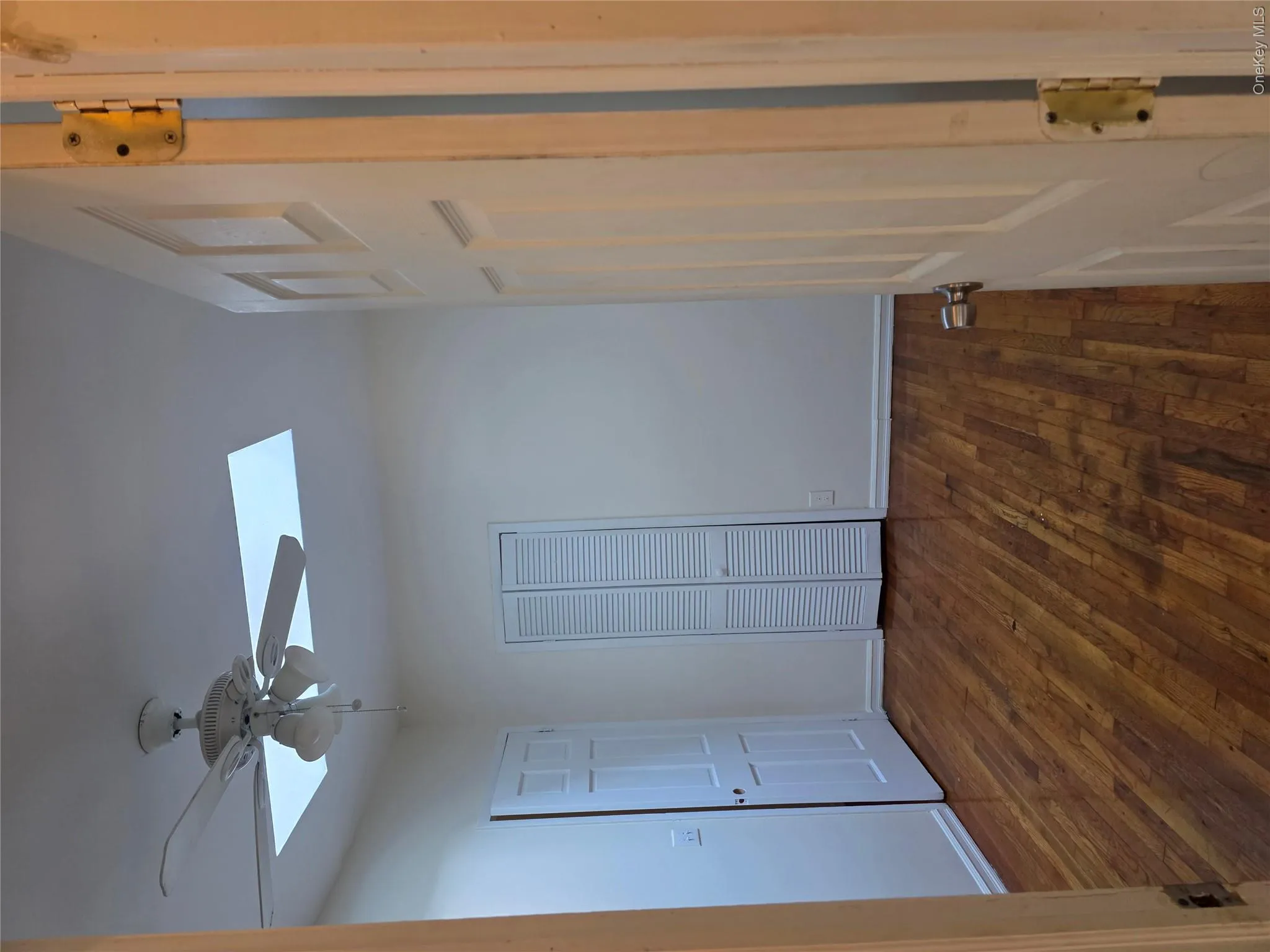 Unfurnished bedroom featuring a skylight, dark wood finished floors, a closet, and ceiling fan Unfurnished bedroom featuring a skylight, dark wood finished floors, a closet, and ceiling fan