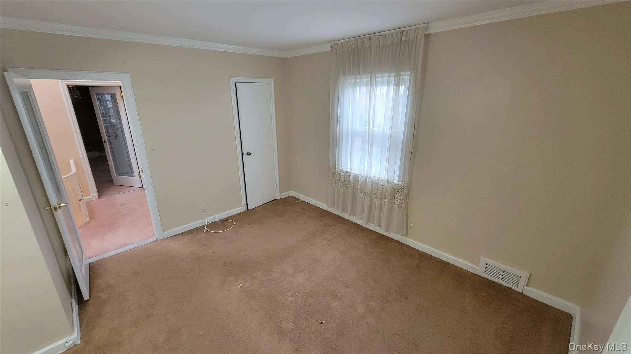 Unfurnished bedroom with carpet and ornamental molding Unfurnished bedroom with carpet and ornamental molding