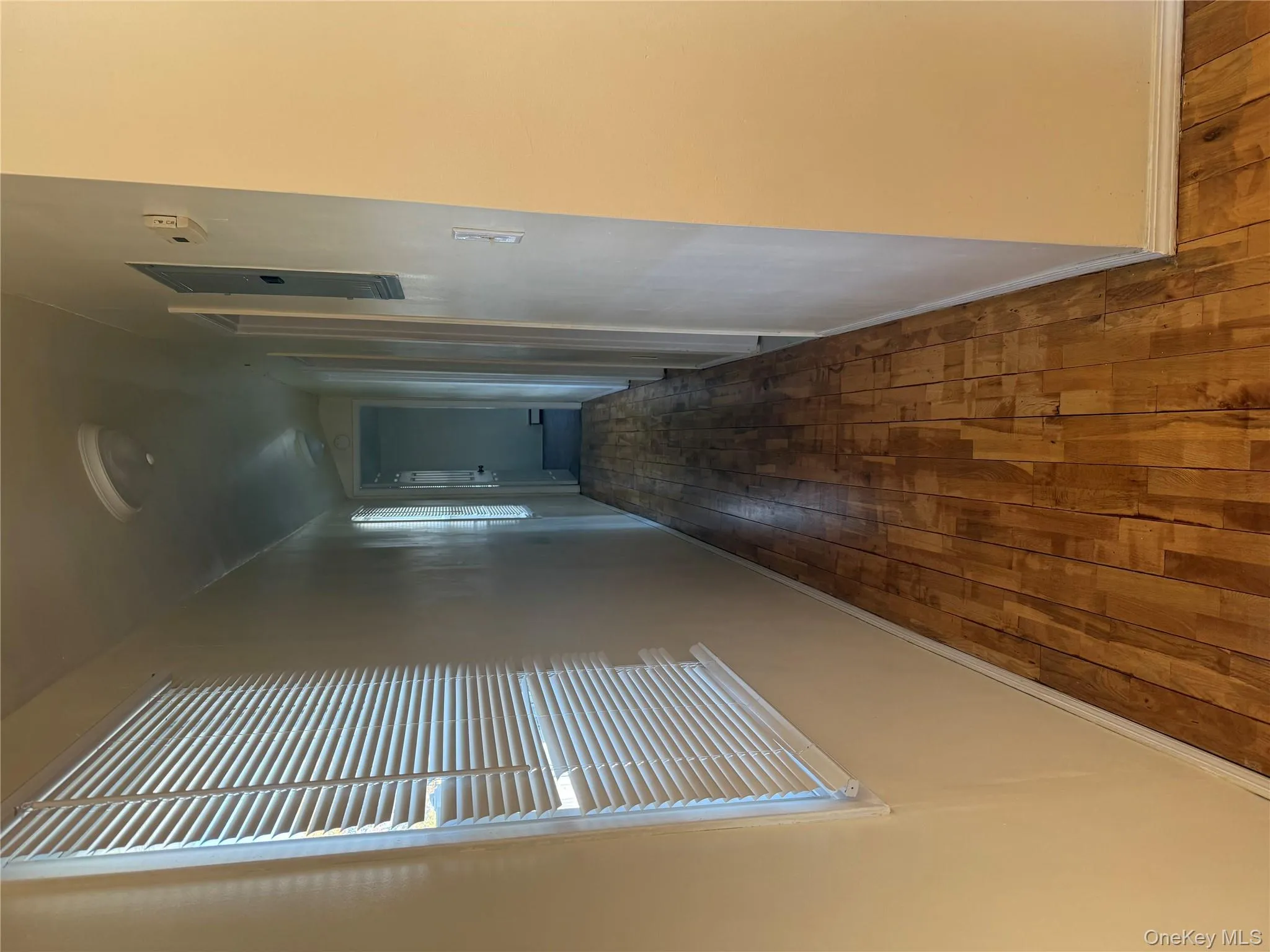 Corridor featuring hardwood / wood-style floors Corridor featuring hardwood / wood-style floors