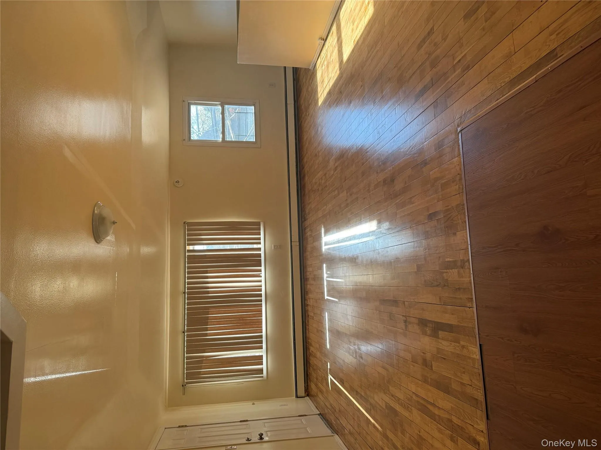 Spare room with hardwood / wood-style flooring and a baseboard radiator Spare room with hardwood / wood-style flooring and a baseboard radiator